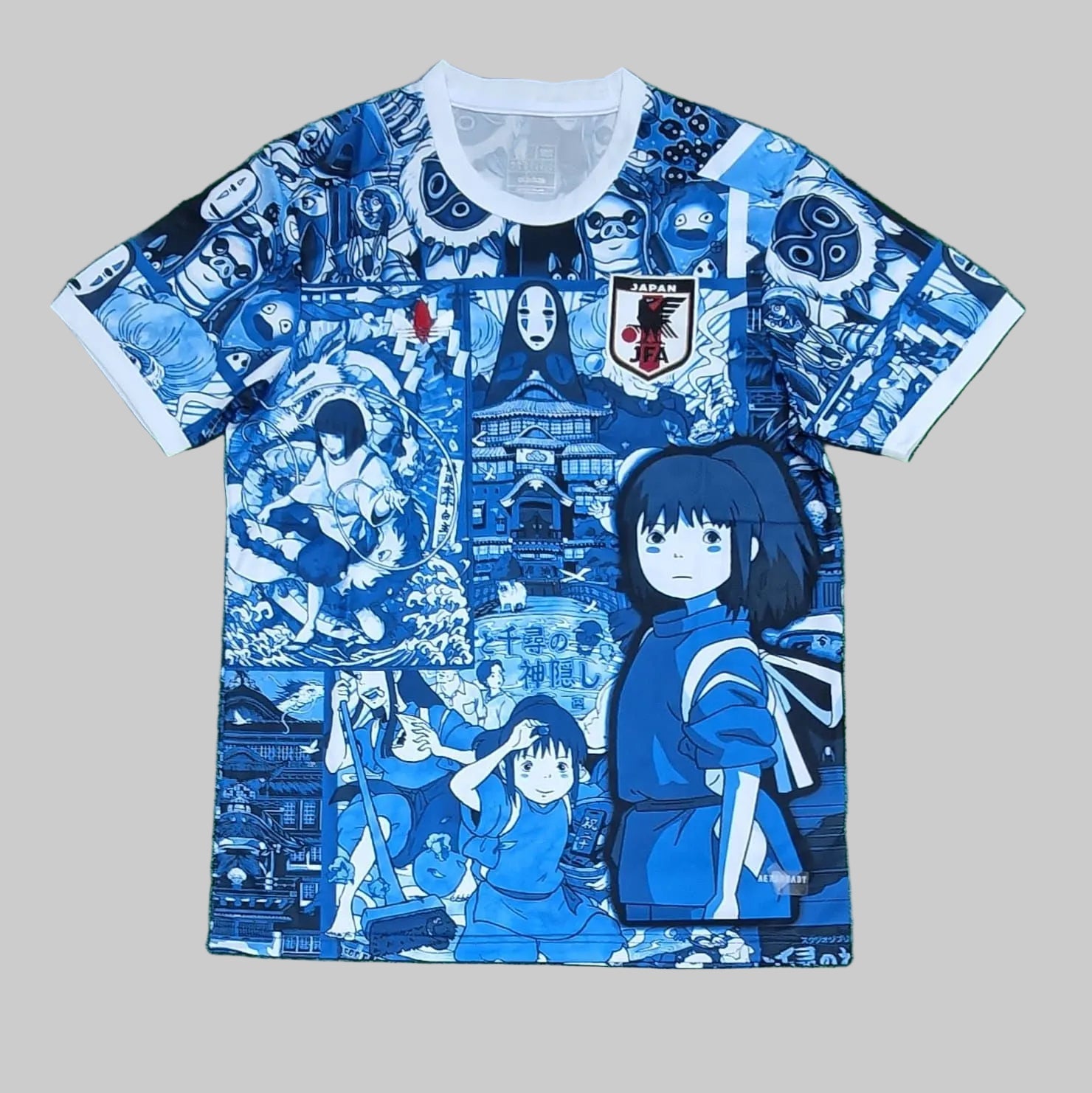 Blue and white t-shirt with anime character design on a green background