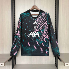 Liverpool Shirt with colorful design and brand logos on a hanger against a neutral background