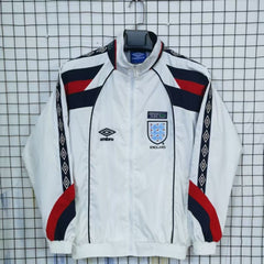 England White tracksuit with red and blue accents on a checkered background