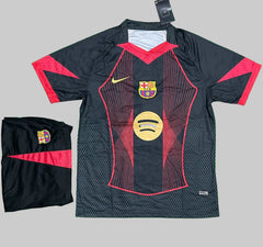 Barcelona sports jersey with red accents and visible branding on a green surface