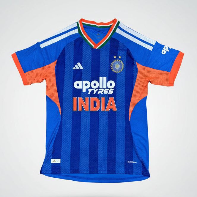 INdia T20 World Cup Cricket jersey with orange accents on a green background, featuring Apollo Tyres and India branding.