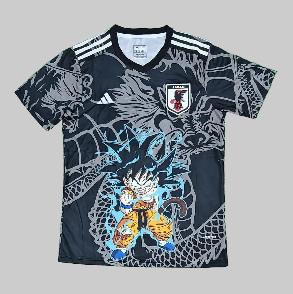 Soccer jersey with a dragon design on a green grass-like background