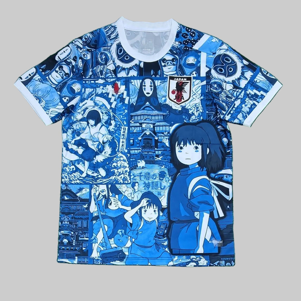 Blue and white t-shirt with anime character design on a green background