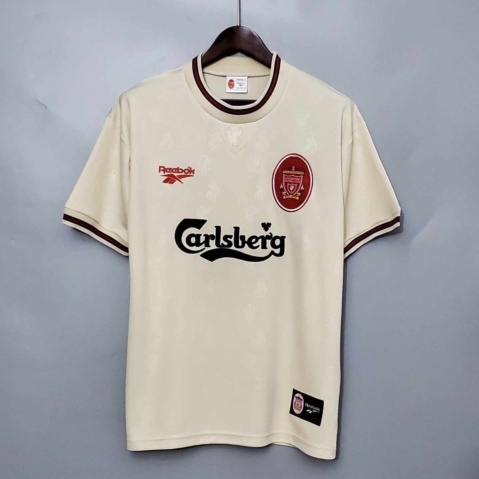 Liverpool 1996-97 Away Retro Jersey in ecru color with green collar, displaying the Carlsberg sponsor logo and the Liverpool FC crest.