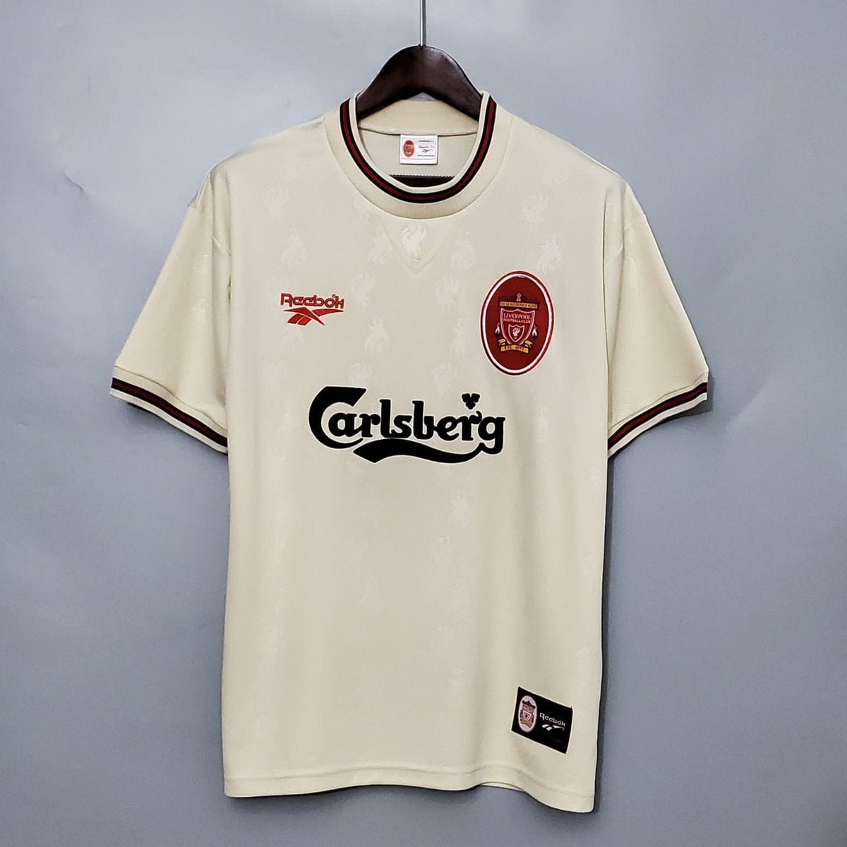 Liverpool 1996-97 Away Retro Jersey in ecru color with green collar, displaying the Carlsberg sponsor logo and the Liverpool FC crest.
